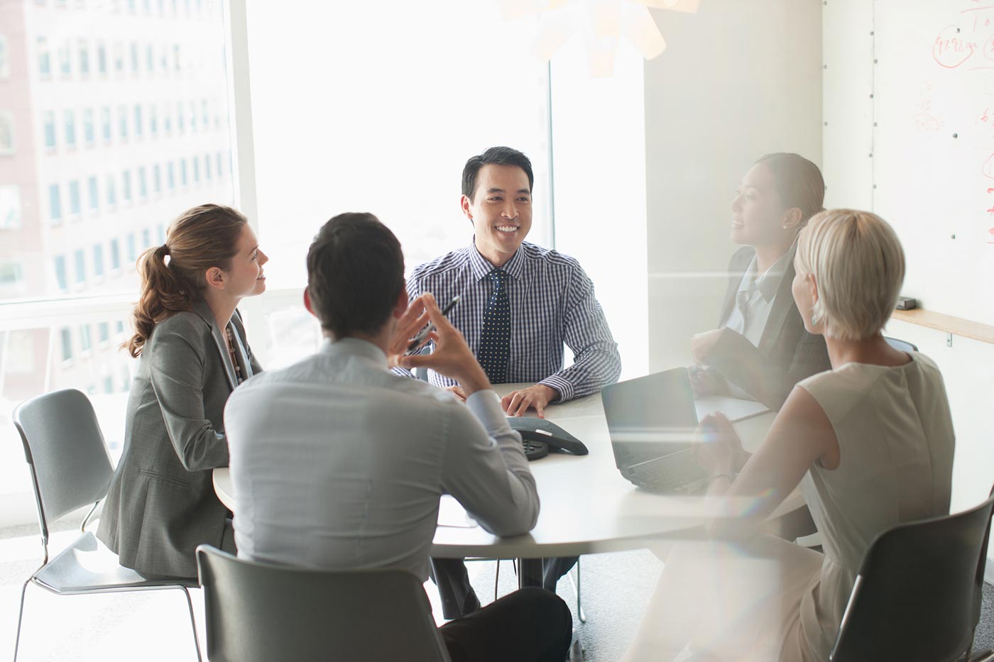 Business leader at a table with coworkers.