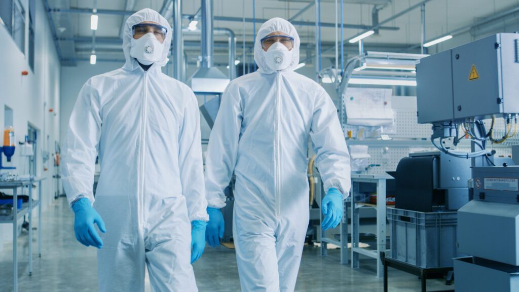 Cleanroom environment photo of two people walking through the room.