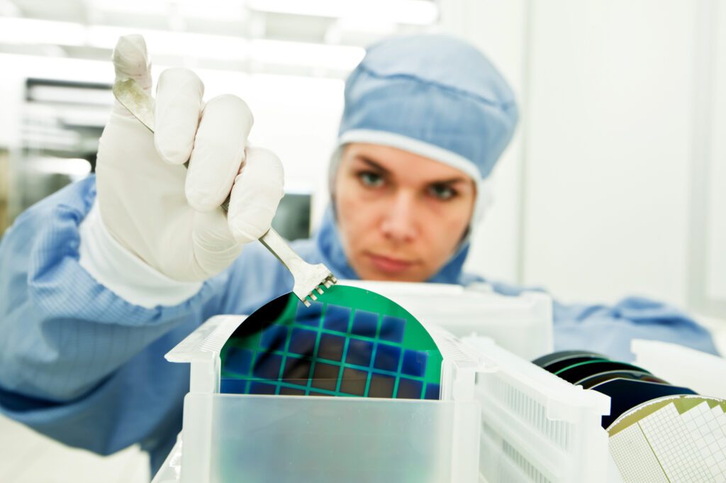 Woman working on silicon wafer.